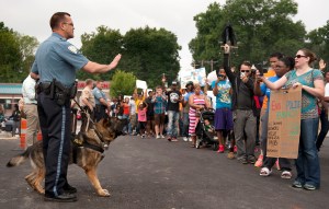 Protestors confront police during an impromptu rally, Sunday, Aug. 10, 2014 to protest the shooting of Michael Brown, 18, by police in Ferguson, Mo. Saturday, Aug. 9, 2014. Brown died following a confrontation with police, according to St. Louis County Police Chief Jon Belmar, who spoke at a news conference Sunday. (AP Photo/Sid Hastings)