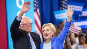Presumptive Democratic presidential candidate Hillary Clinton and Bernie Sanders wave after speaking at a rally in Portsmouth, N.H. earlier this month